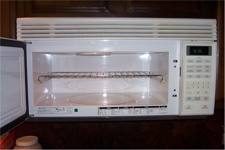 Picture Of Microwave Oven With A Metal Shelf